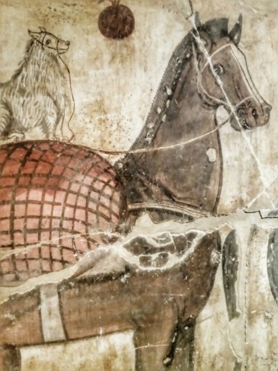 Un cane di razza maltese in groppa ad un cavallo: indica il rango sociale elevato del proprietario della tomba